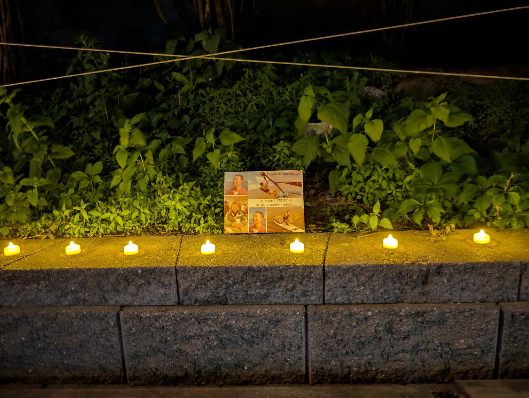 Tea-light candles surrounding Yu Chen's portrait
